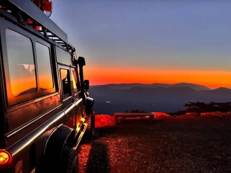 Serengeti Tanzania safari at sunset with safari vehicle